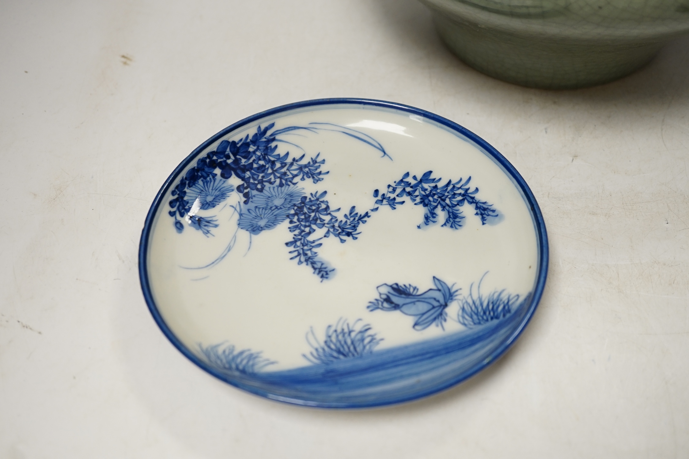 Three pieces of Asian pottery items comprising a Japanese blue and white dish, a green crackleware squat vase and an early 17th century Swatow jarlet, largest 18cm high. Condition - fair